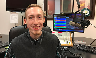 Austen Pontious broadcasting student in DJ booth